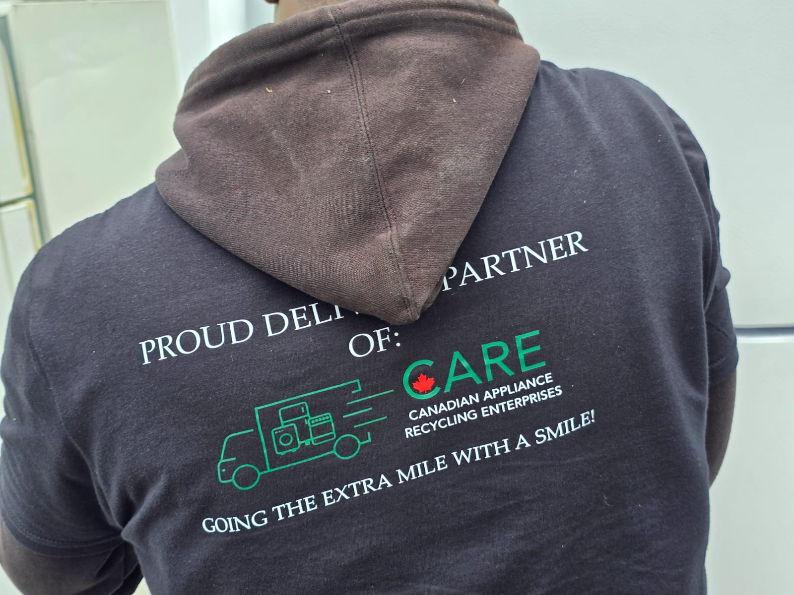 CARE team member wearing branded hoodie - Proud Delivery Partner