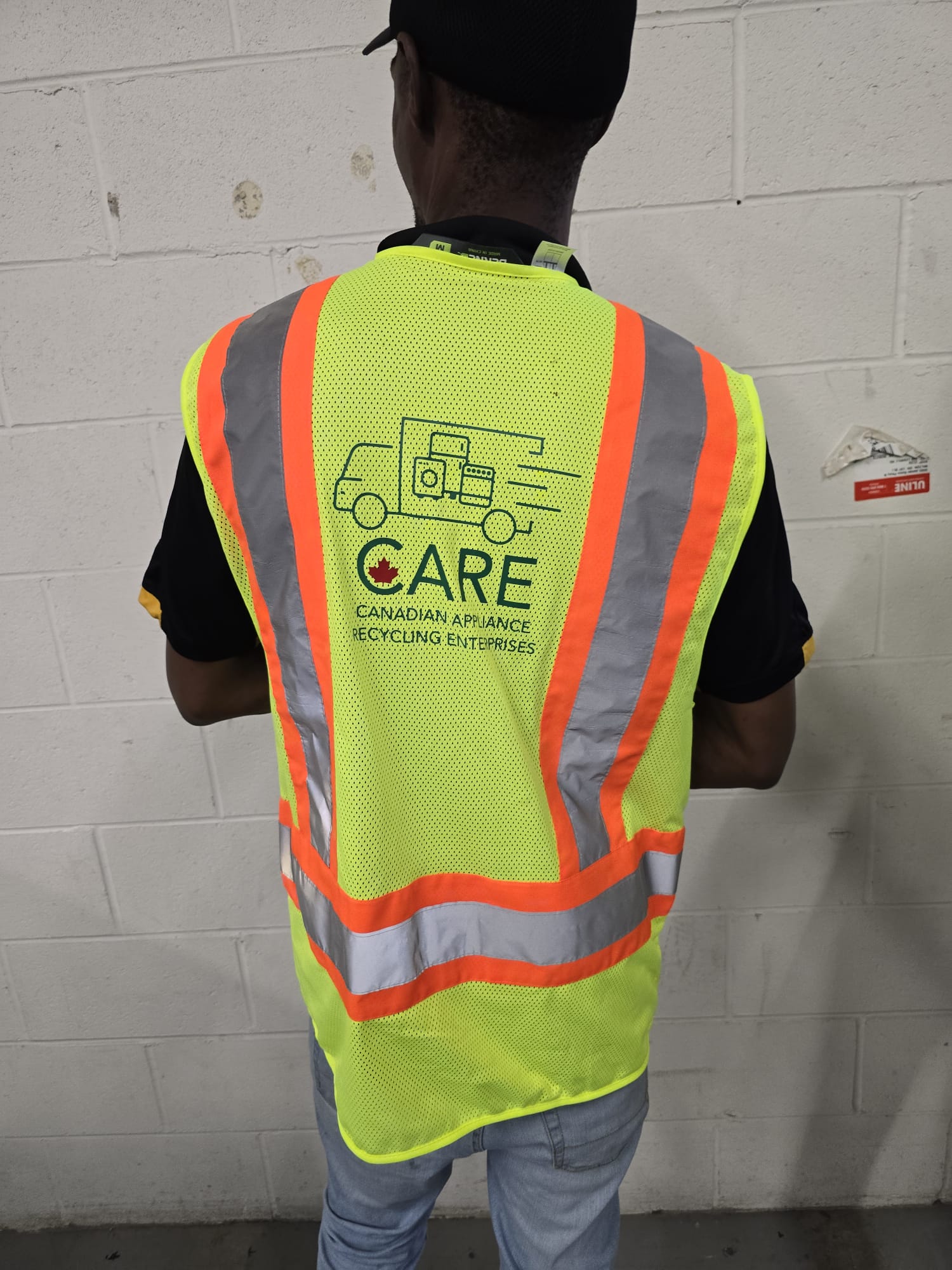 CARE professional in high-visibility safety vest with company branding